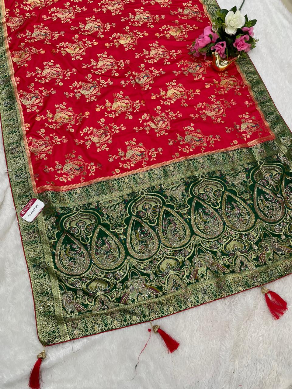 AJ-KASTURI SATIN SILK WITH BEAUTFUL PALLU WITH HEAVY DESIGN WITH JARKAN WORK WITH MEENAKARI WORK AND LUXURIOUS TASSELS WITH CONTRAST BUTTI BLOUSE