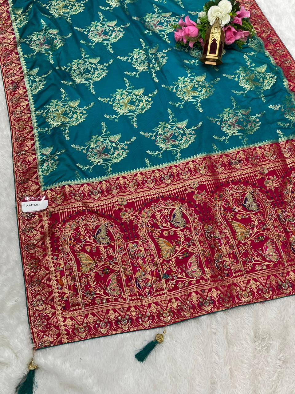 AJ-TITALI  SATIN SILK WITH BEAUTFUL PALLU WITH HEAVY DESIGN WITH JARKAN WORK WITH BEAUTIFUL BUTTERFLY DESIGN ON BODY AND PALLU WITH MEENAKARI WORK AND LUXURIOUS TASSELS WITH CONTRAST BUTTI BLOUSE