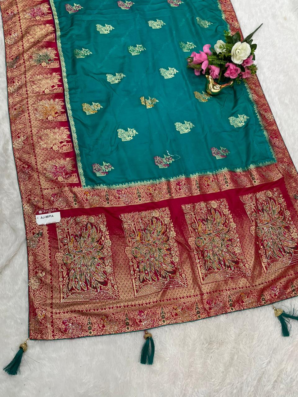 AJ-MIRA SATIN SILK WITH BEAUTFUL GRAND PALLU WITH HEAVY DESIGN WITH JARKAN WORK WITH MEENAKARI WORK AND LUXURIOUS TASSELS WITH CONTRAST BUTTI BLOUSE