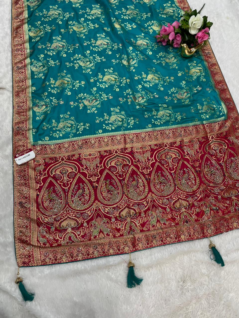 AJ-KASTURI  SATIN SILK WITH BEAUTFUL PALLU WITH HEAVY DESIGN WITH JARKAN WORK WITH MEENAKARI WORK AND LUXURIOUS TASSELS WITH CONTRAST BUTTI BLOUSE