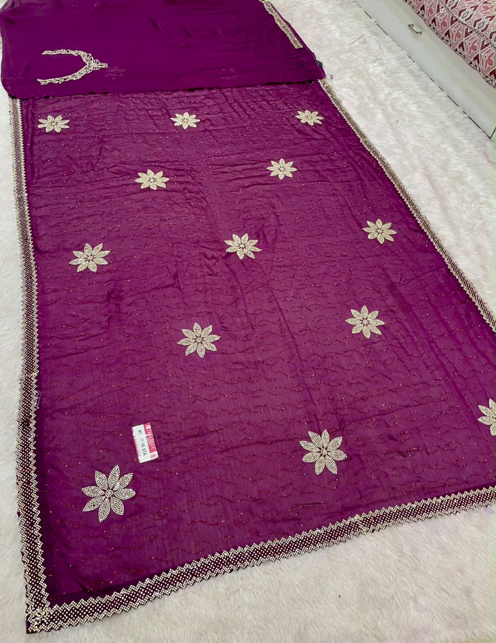 RD-PURE STAR SATIN FABRIC SAREE WITH BEAUTIFUL FLORAL JARKAN & STONE WORK WITH GLITTER HIGHLIGHTS WITH ALL OVER WAVY TEXTURE PATTERN WITH DESIGNER FLOWER BUTTIS AND MATCHING DESIGNER BLOUSE WITH NECK WORK
