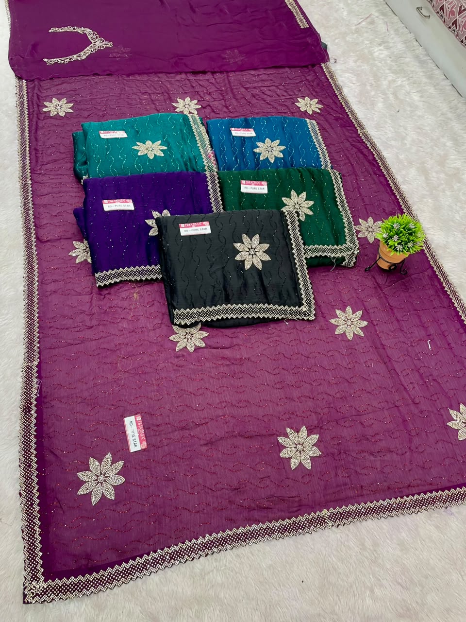 RD-PURE STAR SATIN FABRIC SAREE WITH BEAUTIFUL FLORAL JARKAN & STONE WORK WITH GLITTER HIGHLIGHTS WITH ALL OVER WAVY TEXTURE PATTERN WITH DESIGNER FLOWER BUTTIS AND MATCHING DESIGNER BLOUSE WITH NECK WORK