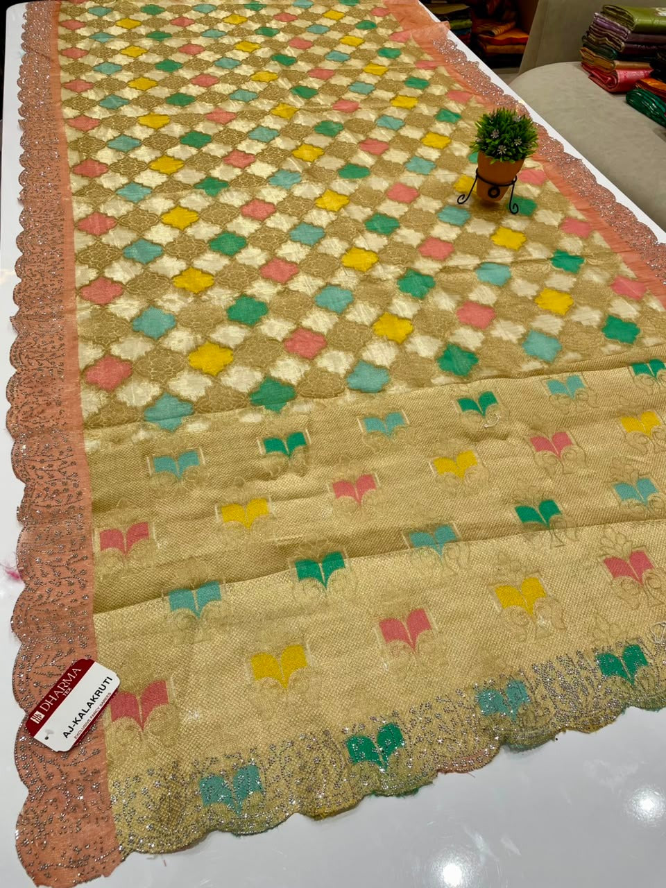 AJ-KALAKRUTI-CATLOGUE A STUNNING FANCY FABRIC SAREE FEATURING RICH MULTI-COLOUR WEAVING, HEAVY SCALLOPED CUTWORK BORDER WITH PREMIUM SIROSKI WORK, AND A BEAUTIFULLY DESIGNED MULTI-COLOUR RICH PALLU, PAIRED WITH A MATCHING BLOUSE PIECE