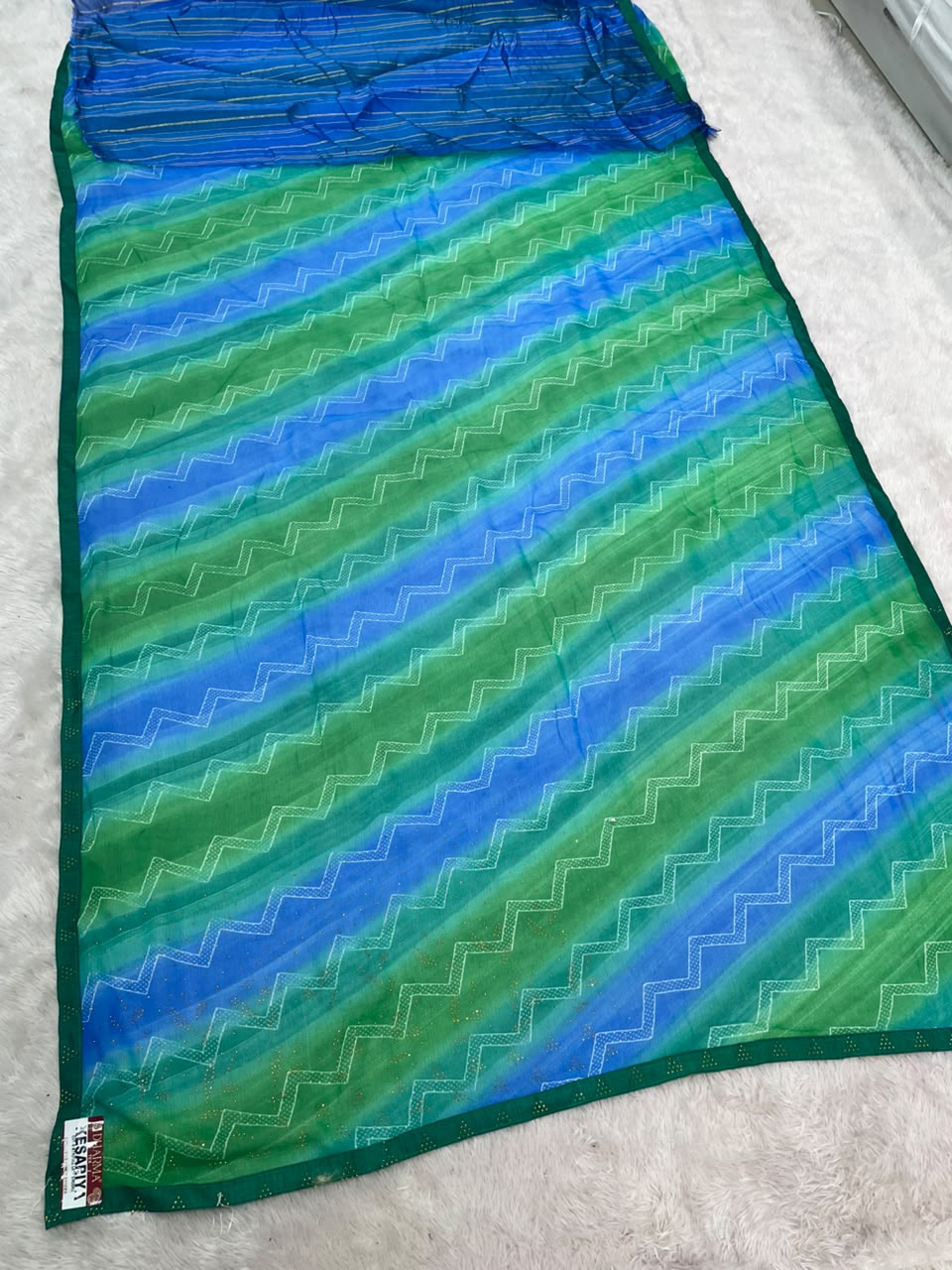 KESARIYA-CATLOGUE WEIGHTLESS FABRIC SAREE WITH BEAUTIFUL LEHARIYA DESIGN WITH DMC SIROSKI WORK ALL OVER ON SAREE WITH BLOUSE