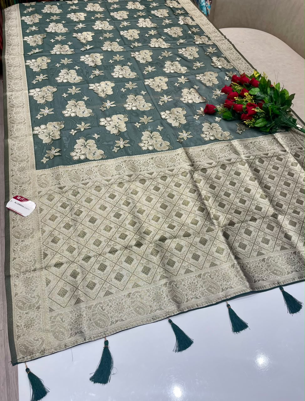 AJ-ZARINA-DARK  FANCY FABRIC SAREE WITH HEAVY RICH PALLU DESIGN WITH FLORAL DESIGN ALL OVER ON BODY WITH PIPING AND TASSELS WITH BLOUSE