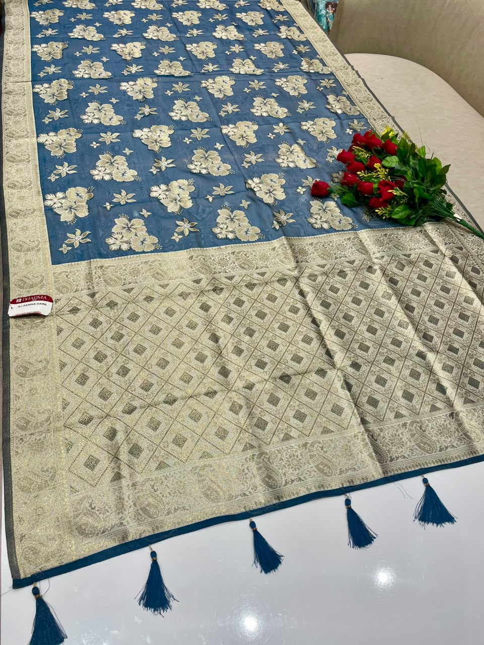 AJ-ZARINA-DARK  FANCY FABRIC SAREE WITH HEAVY RICH PALLU DESIGN WITH FLORAL DESIGN ALL OVER ON BODY WITH PIPING AND TASSELS WITH BLOUSE