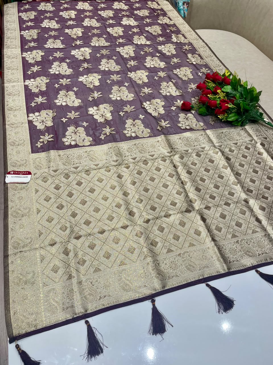 AJ-ZARINA-DARK  FANCY FABRIC SAREE WITH HEAVY RICH PALLU DESIGN WITH FLORAL DESIGN ALL OVER ON BODY WITH PIPING AND TASSELS WITH BLOUSE