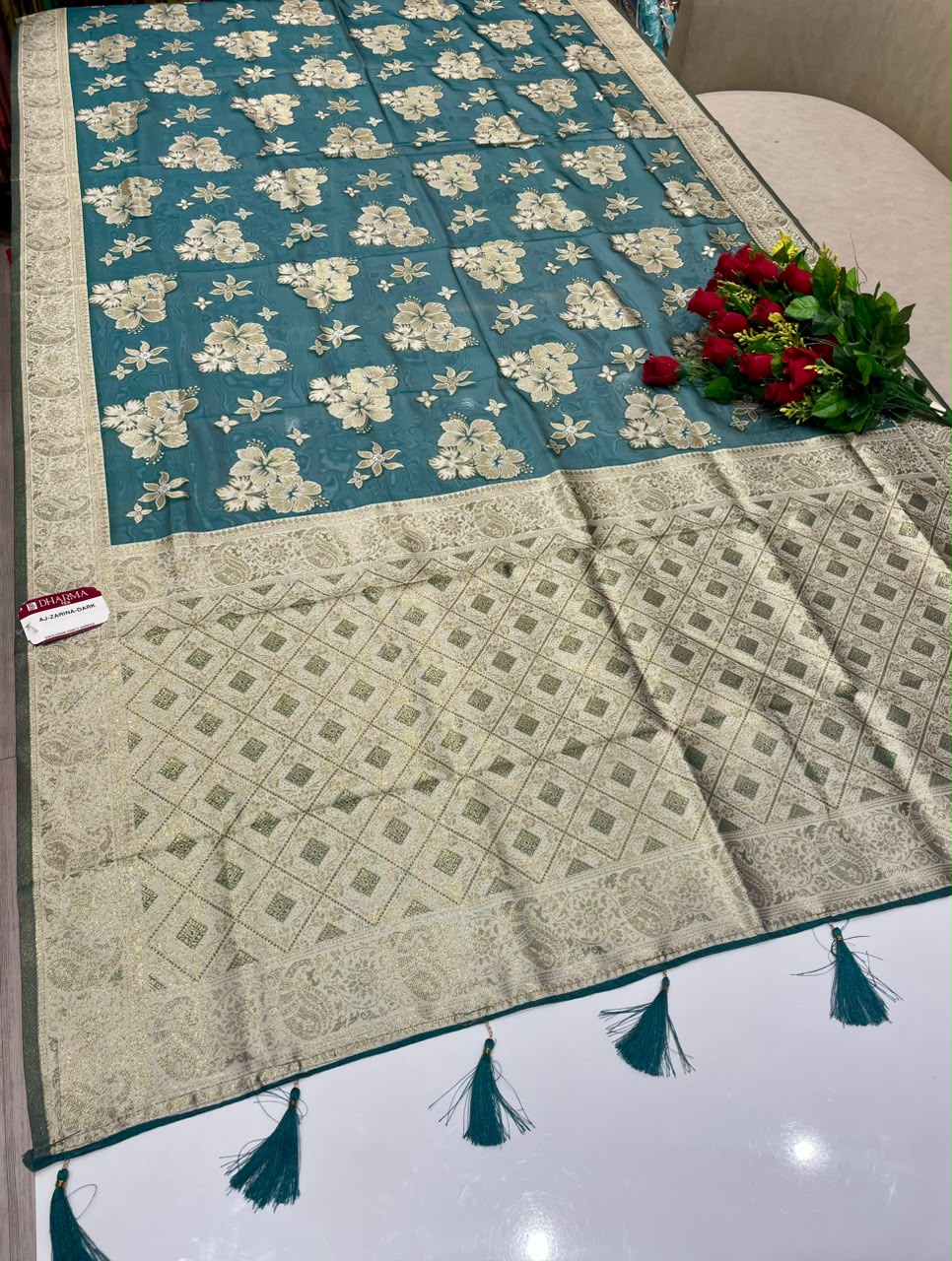 AJ-ZARINA-DARK  FANCY FABRIC SAREE WITH HEAVY RICH PALLU DESIGN WITH FLORAL DESIGN ALL OVER ON BODY WITH PIPING AND TASSELS WITH BLOUSE
