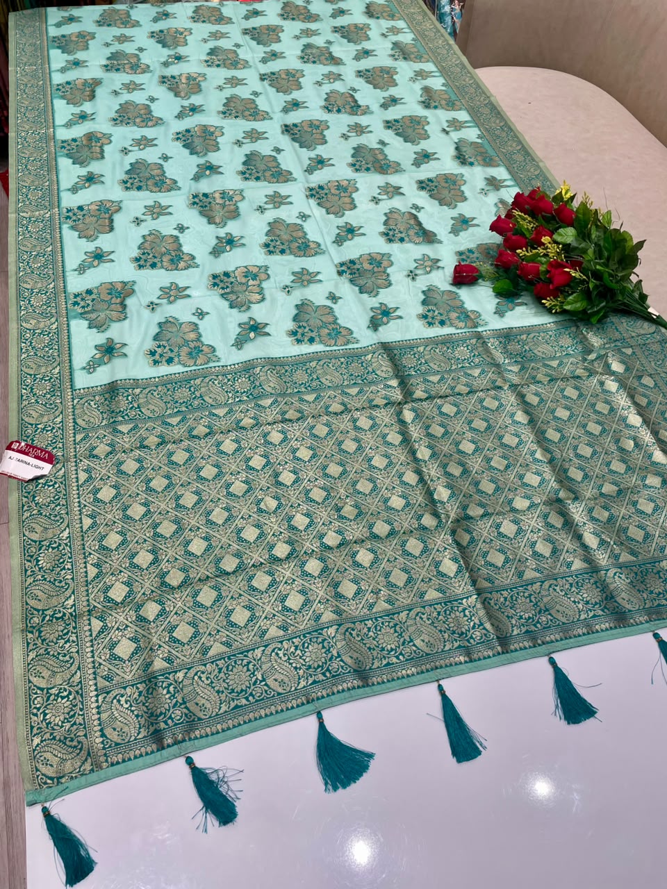 AJ-ZARINA-LIGHT FANCY FABRIC SAREE WITH HEAVY RICH PALLU DESIGN WITH FLORAL DESIGN ALL OVER ON BODY WITH PIPING AND TASSELS WITH BLOUSE
