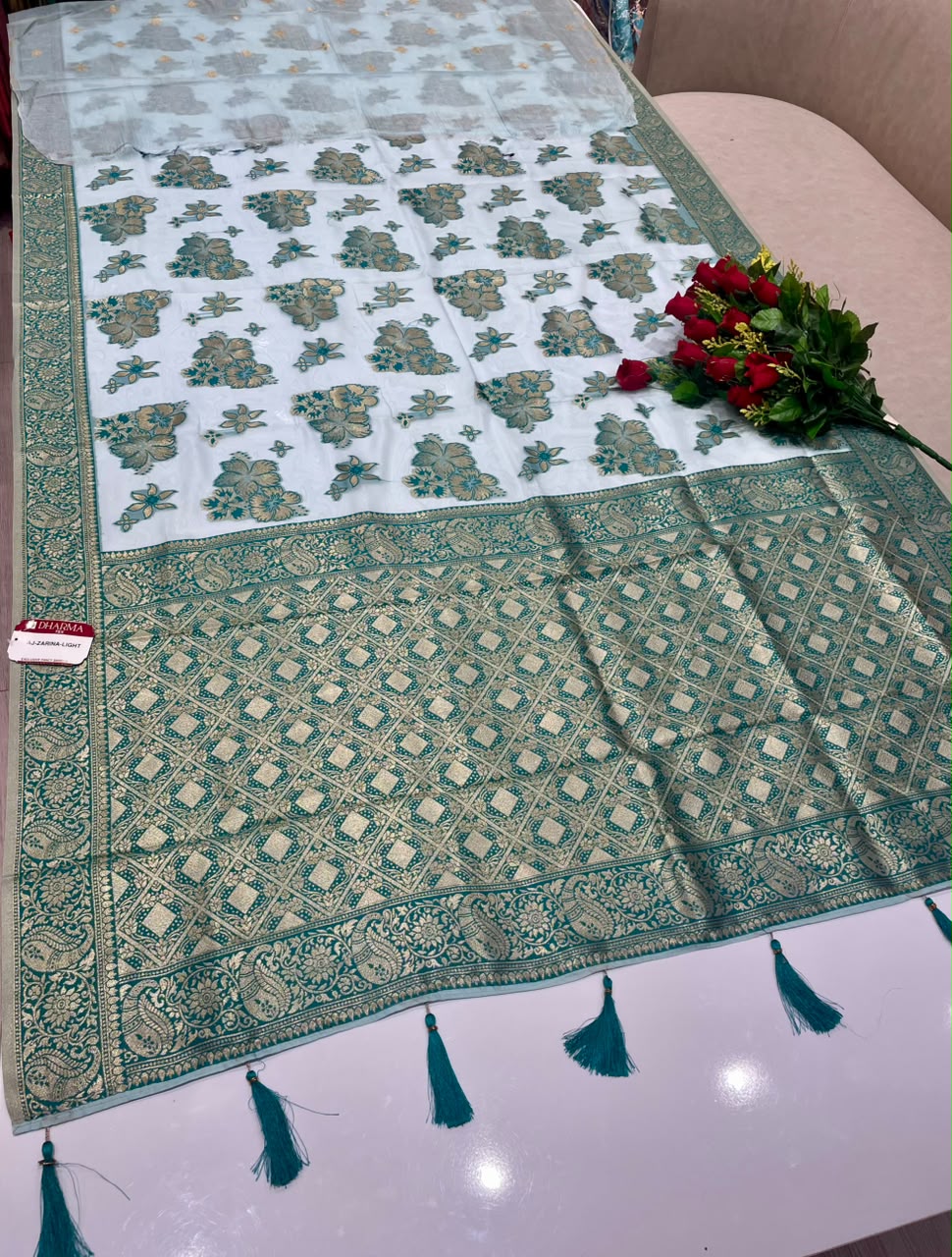 AJ-ZARINA-LIGHT FANCY FABRIC SAREE WITH HEAVY RICH PALLU DESIGN WITH FLORAL DESIGN ALL OVER ON BODY WITH PIPING AND TASSELS WITH BLOUSE
