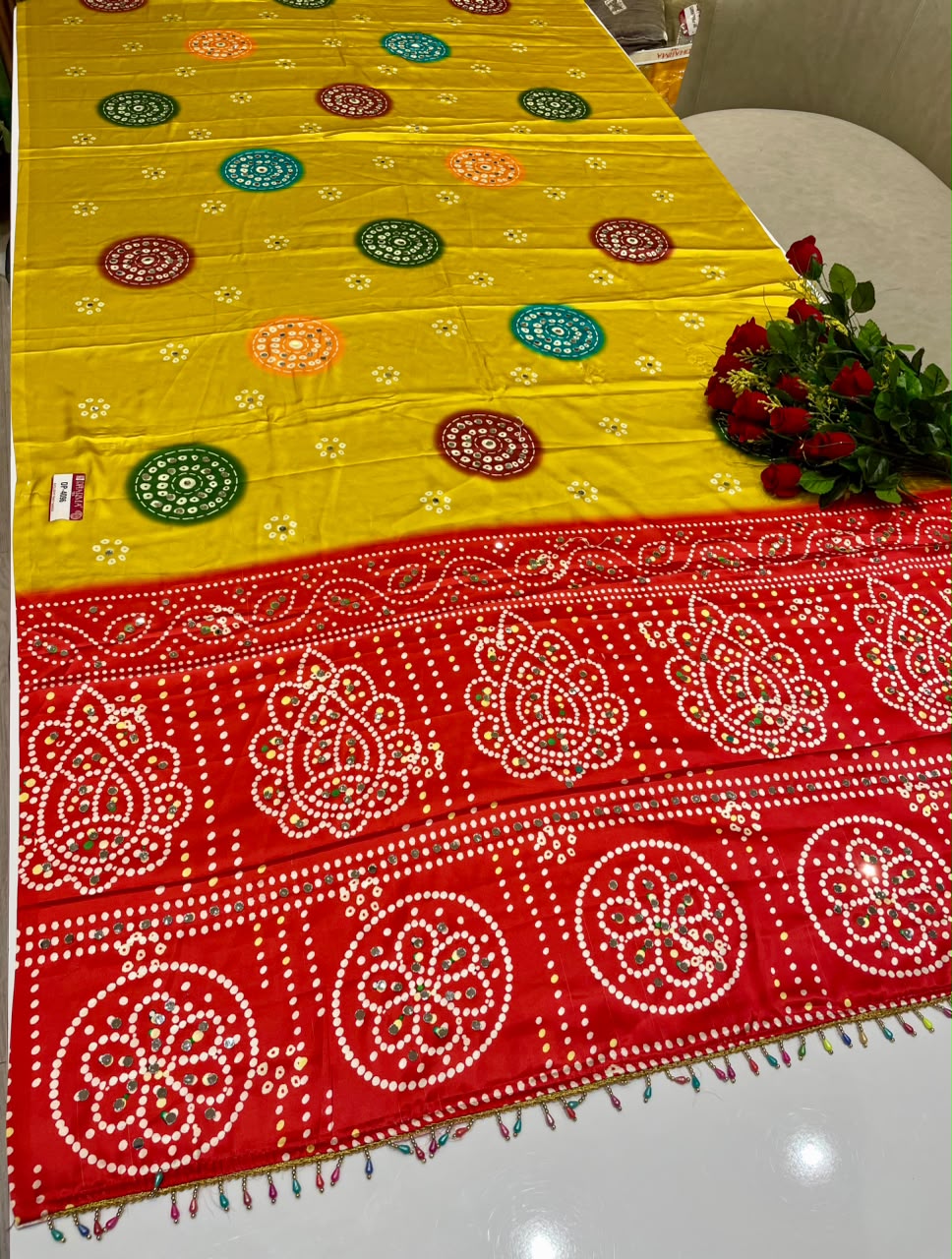DP-4096 JAPAN SATIN FABRIC SAREE WITH BEAUTIFUL DESIGN WITH HEAVY MIRROR WORK ON SAREE WITH BANDHANI DESIGN WITH HEAVY TASSELS WITH BLOUSE