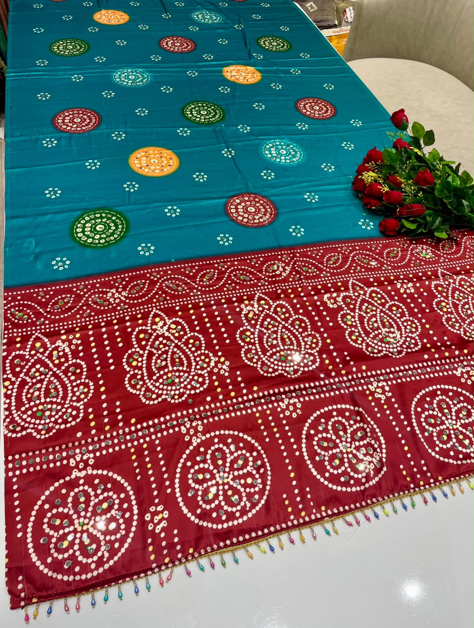 DP-4096 JAPAN SATIN FABRIC SAREE WITH BEAUTIFUL DESIGN WITH HEAVY MIRROR WORK ON SAREE WITH BANDHANI DESIGN WITH HEAVY TASSELS WITH BLOUSE