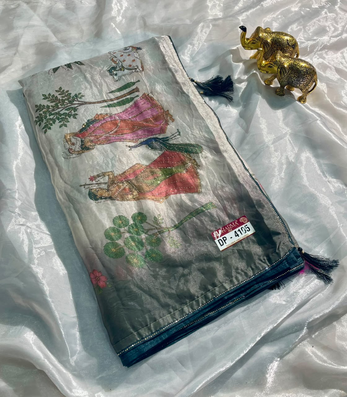DP-4105 FENDI SATIN FABRIC SAREE WITH BEAUTIFUL DESIGN WITH COW AND OTHER BEAUTIFUL PRINT WITH DMC SIROSKI WORK WITH PIPING AND TASSELS WITH BLOUSE