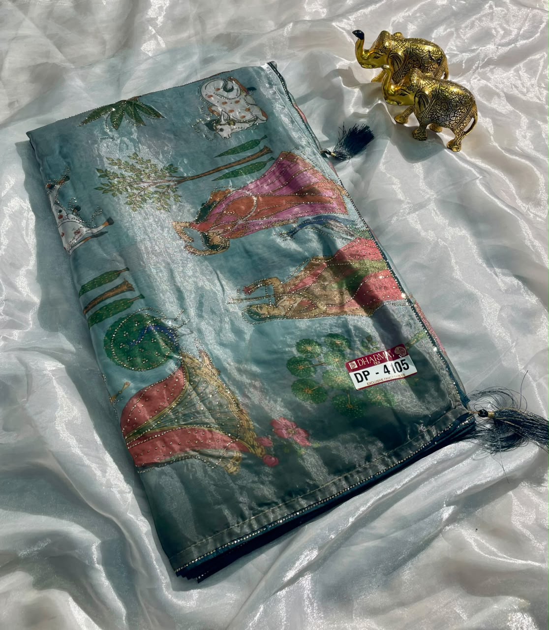 DP-4105 FENDI SATIN FABRIC SAREE WITH BEAUTIFUL DESIGN WITH COW AND OTHER BEAUTIFUL PRINT WITH DMC SIROSKI WORK WITH PIPING AND TASSELS WITH BLOUSE